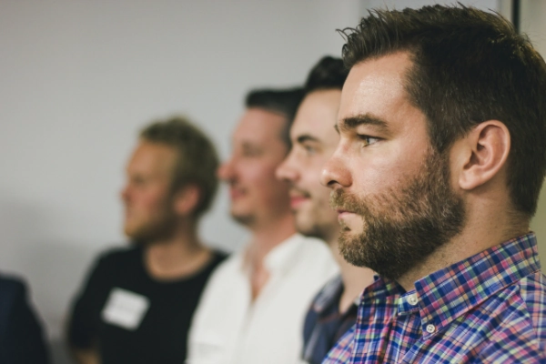 photo of four men sitting at a group therapy meeting